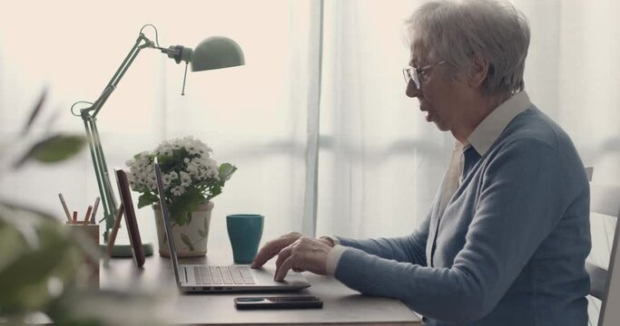Frustrated senior woman having problems with her computer