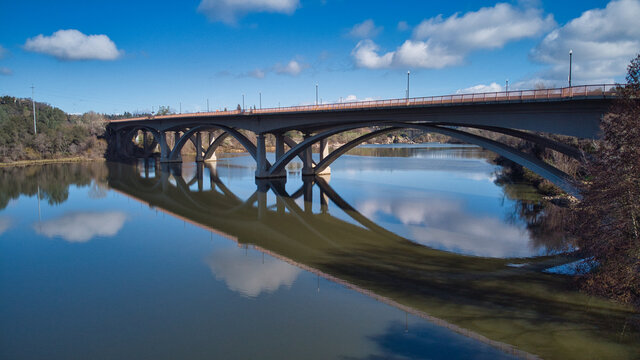 Aerial view of bridge with reflections in the water