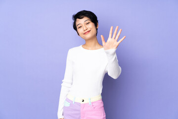 Young Vietnamese woman with short hair over isolated purple background counting five with fingers