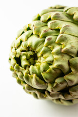 Obraz premium Detail shot of artichoke, on white background, vertically, with copy space