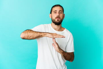 Young man with long hair look showing a timeout gesture.