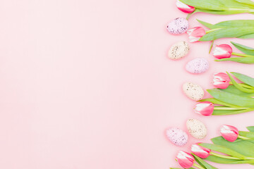 Fototapeta na wymiar Flat lay easter composition with pink tulips and eggs on pink background