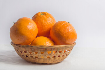 basket with oranges isolated on  cloth background