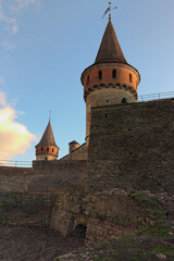 Scenic landscape photo of ancient Kamianets-Podilskyi Castle. High and thick stone walls with towers against blue sky. Abstract photo of stone walls. Ukraine © evgenij84