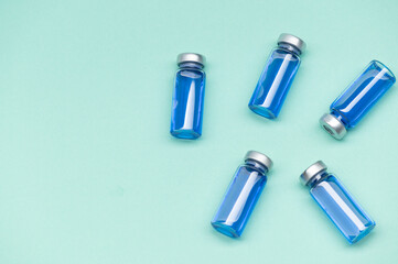 Corona Virus vaccine vials medicine bottles. SARS-CoV-2 Vaccination and immunization, treatment to cure Covid 19 Corona Virus infection. Medical concept. Flat lay. Top View. Copy space.