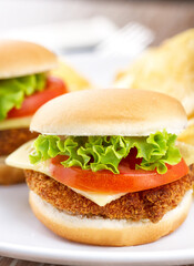 Mini Crispy Chicken Burger with Lettuce Tomato and Cheese.