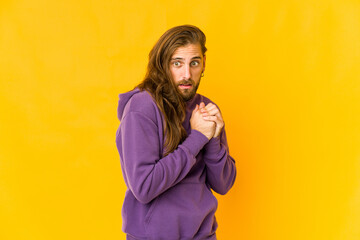 Young man with long hair look scared and afraid.
