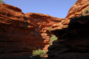 A beautiful red rock canyon seen in shadow and light in the outback of the Northern Territory of Australia.