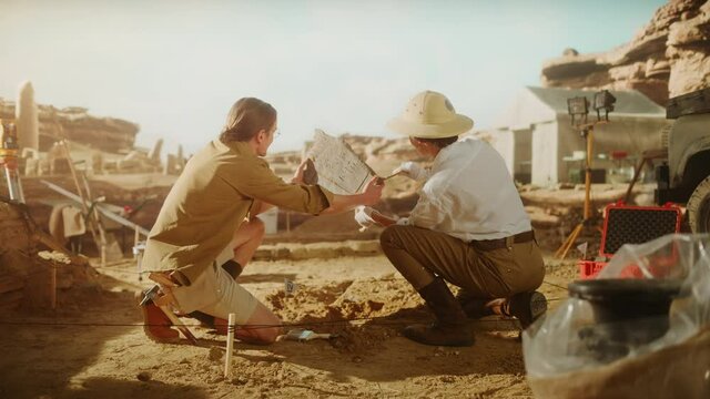 Archeological Digging Site: Two Great Archeologists Work on Excavation Site, Carefully Lifting Newly Discovered Ancient Civilization Cultural Artifact, Historical Clay Tablet, Fossil Remains