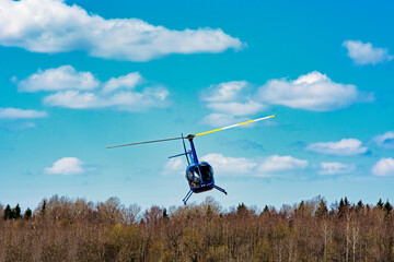 helicopter robinson 44 flies in the sky - obrazy, fototapety, plakaty
