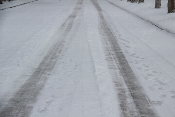 Vehicle ruts in the snow. Frozen road with print from wheels.