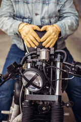 Obraz premium Close up set of an attractive driver. Close up motorcycle detail. Black helmet and yellow gloves of a motorcycle driver. Hipster lifestyle. Outdoor concept