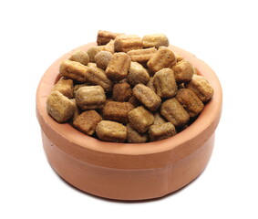 Dry dog food with bacon in clay pot, granules isolated on white background