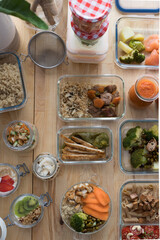Overhead view of many glass jars full of veggie delicious meal ready to be taken away.