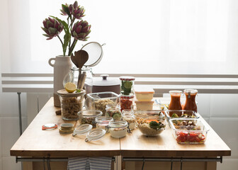 Complete batch cooking scene over a wooden kitchen table.