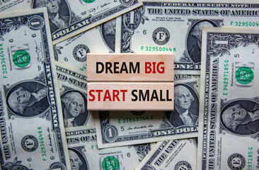 Dream big start small symbol. Concept words 'dream big start small' on wooden blocks on a beautiful...