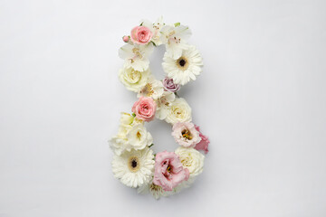Number 8 made of beautiful flowers on white background, flat lay. International Women's day