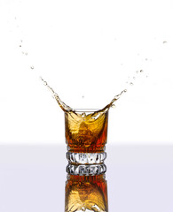 a glass of whiskey with ice on a white background