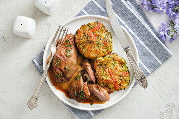 Duck breast in sauce with vegetable cutlets.
