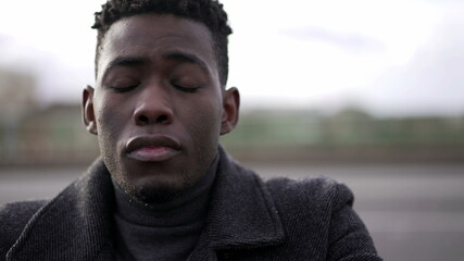 Fototapeta premium Young man preoccupied, black man eyes closed