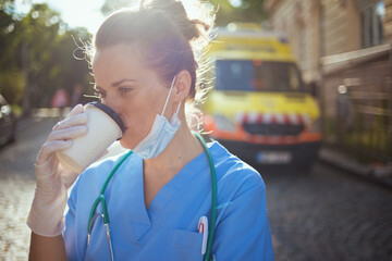 medical doctor woman with stethoscope, medical mask and coffee