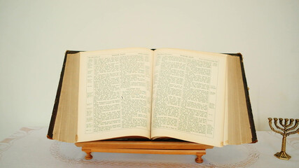 Fototapeta na wymiar Old book Bible on table with menorah