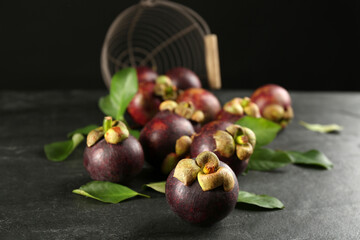 Fresh ripe mangosteen fruits on dark grey table