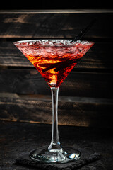 Red alcoholic cocktail with tequila, strawberry syrup and crushed ice, in a cocktail glass
