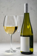 White Wine bottle with empty label and glasses, mockup logo design