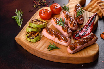 Tasty, fresh sausages grilled with vegetables spices and herbs