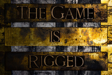 The Game Is Rigged text on vintage textured grunge copper and gold background