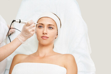 Permanent makeup. Beauty spa procedure. young woman. Face tattoo. Eyeliner micropigmentation....