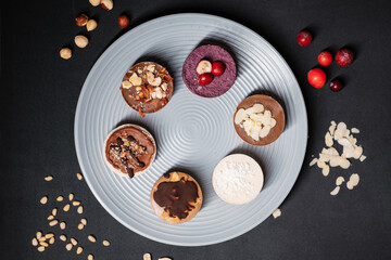 Several cakes are symmetrically laid out on a plate. Food delivery. Homemade baking.