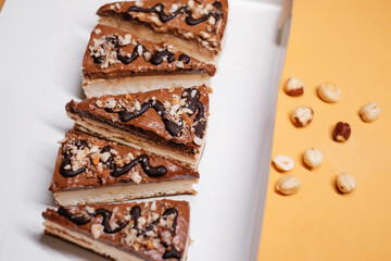 cakes with nuts and chocolate in a cardboard box. Food delivery. Homemade baking.