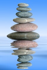 Pyramid from stones in water on a blue background