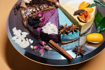 Several cakes are symmetrically laid out on a metal plate. Food delivery. Homemade baking. close up.