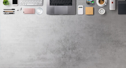 Flat lay top view office desk working space with laptop and supplies on gray background. Copy space.
