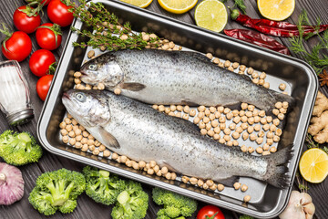 Fish trout with chickpeas in metal tray