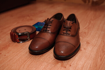 Brown men's shoes. belt. perfume. wedding rings. Groom's accessories
