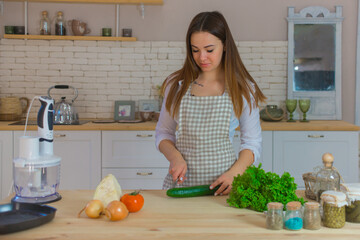 young woman holds vegetables in her kitchen. healthy eating and diet