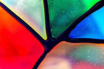 Light coming through a colored candle holder, seen very close