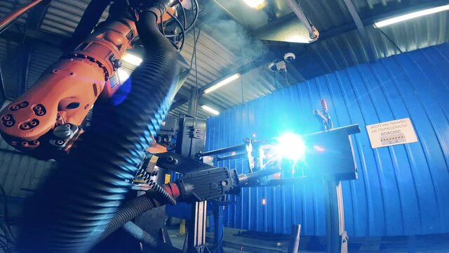 Automatic robot arm welding a bicycle fork
