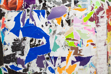 Torn and peeling colourful paper. Abstract grunge background with ripped pieces of colored paper. Creative background.