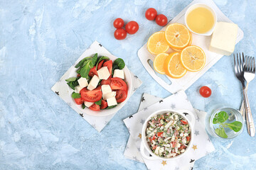 Fototapeta na wymiar Vegetable salad with mozzarella cheese, cherry tomatoes and fresh arugula, Healthy natural breakfast with lemon, detox diet. Traditional Italian food, cholesterol and GMO free, selective focus,