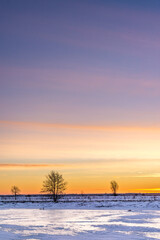 Beautiful sunrise over a frozen landscape in the middle of winter.