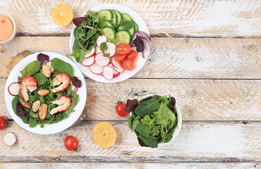 Vegetable salad with shrimps, cucumber, cherry tomatoes, radishes, honey and fresh arugula, Healthy natural breakfast with lemon, detox diet concept, no cholesterol and GMOs, selective focus,