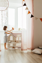 Girl playing with doll house