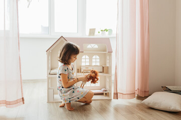 Girl playing with doll house - Powered by Adobe