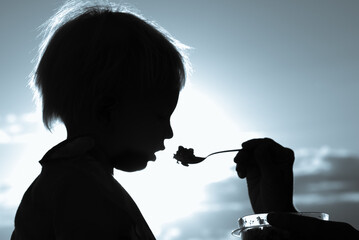 Child eating food from spoon. Children's diet and nutrition concept 