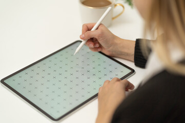 Young beautiful women with glasses using digital tablet with pen mock up on white table, white...
